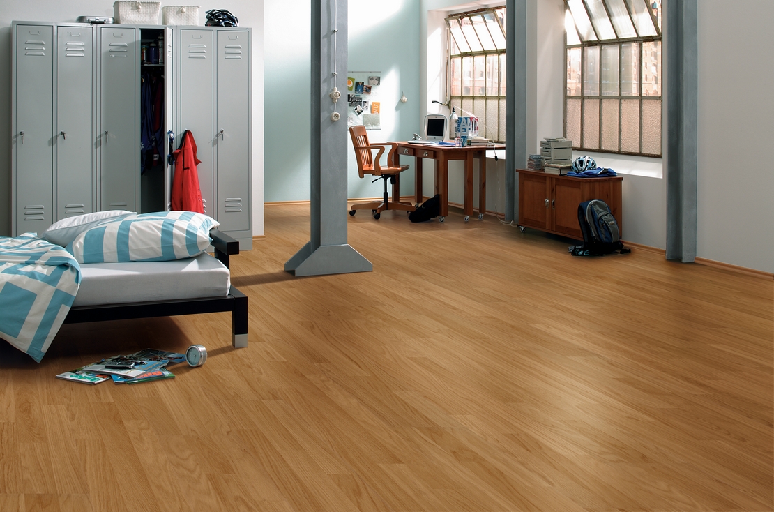 Modern industrial style bedroom, oak wood-effect laminate flooring.