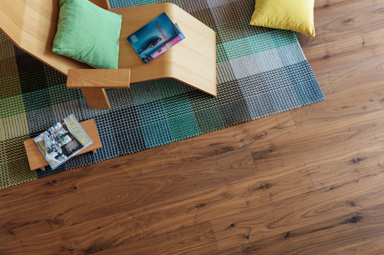 Modern open-plan living room with walnut parquet