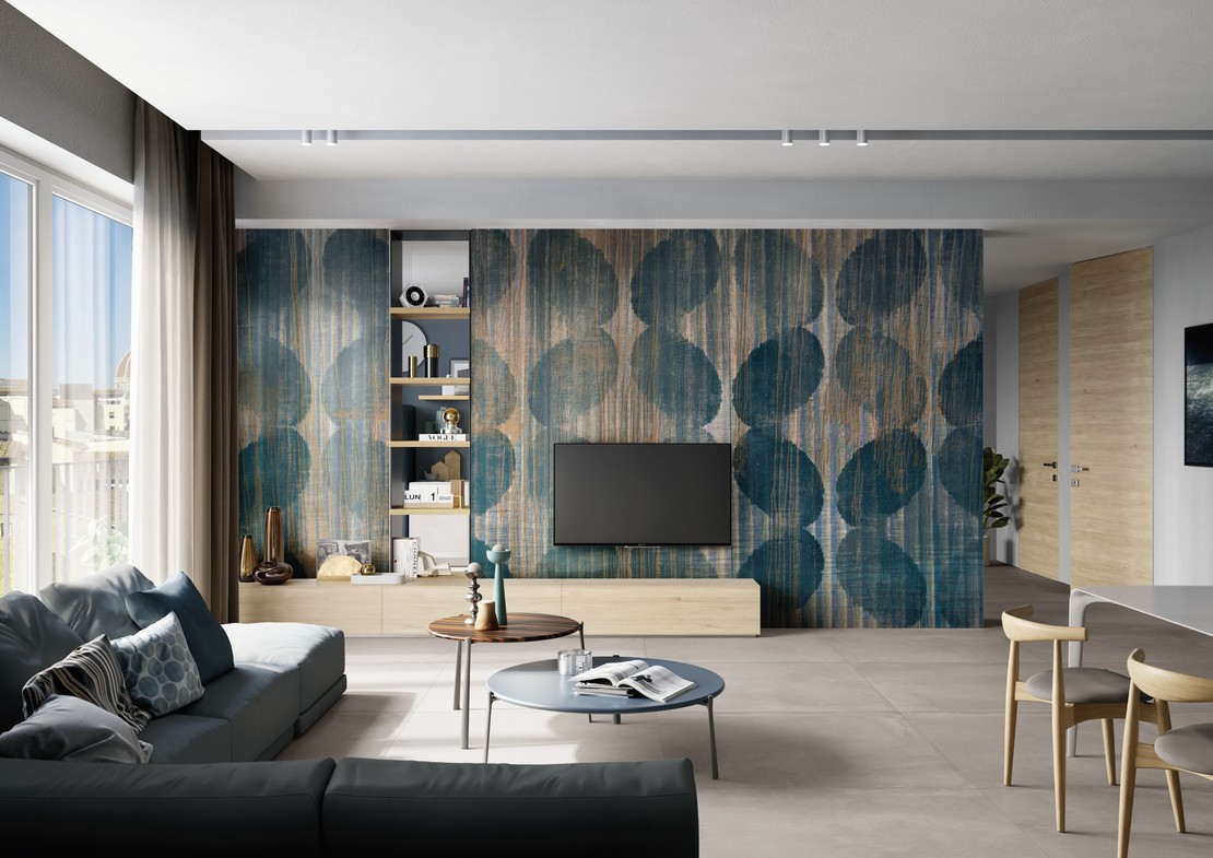 Modern industrial living room with concrete-effect flooring and wallpaper.