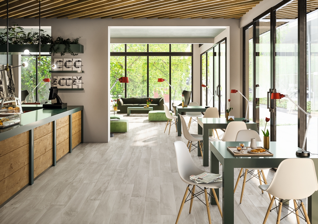 Modernes Restaurant-Cafe mit grauem Feinsteinzeug in Holzoptik und Weißtönen - Inspirationen Iperceramica