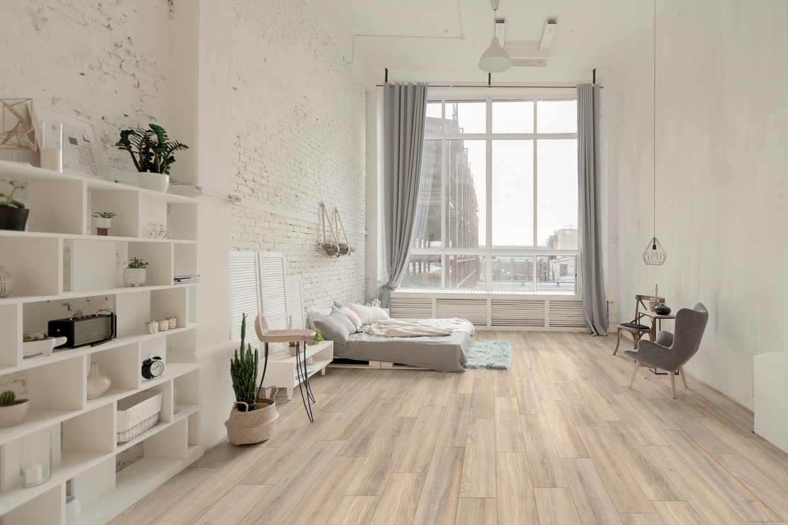 Modern white and beige bedroom with industrial wood-effect flooring