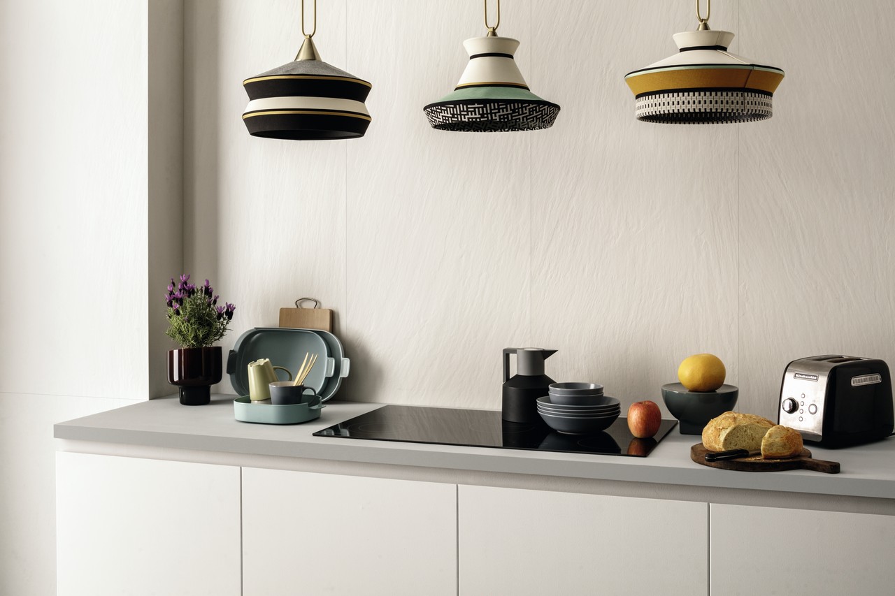 Small linear kitchen with white stone-effect stoneware cladding