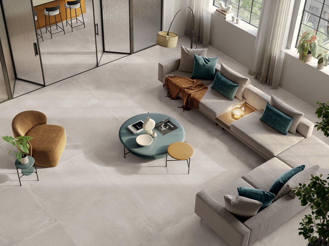 Large modern living room with gray concrete-effect tiles