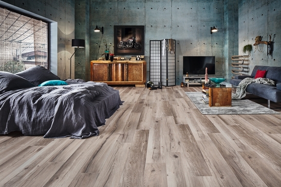 Modern bedroom in industrial style, vintage gray wood-effect laminate.
