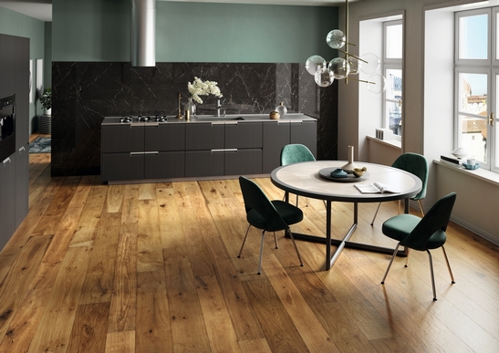 Petite cuisine linéaire. Parquet en bois naturel, tons de vert et de noir pour un style moderne.