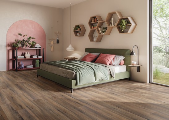 Modern bedroom with wood-effect flooring and pink walls