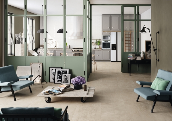 Modern living room, concrete-effect flooring and green tones