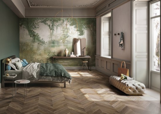 Vintage-rustic bedroom with wallpaper and brown parquet flooring.
