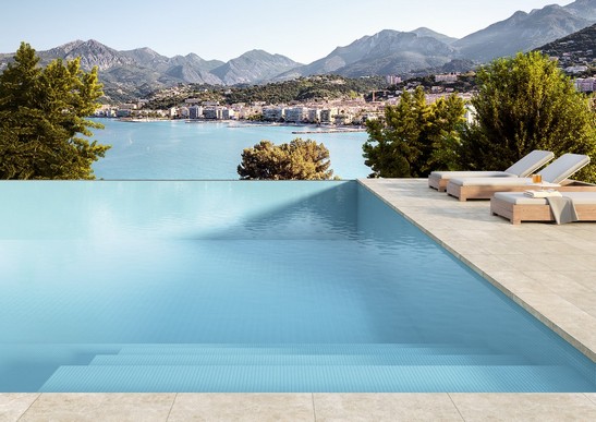 Modern exterior with mosaic pool and stone-effect flooring