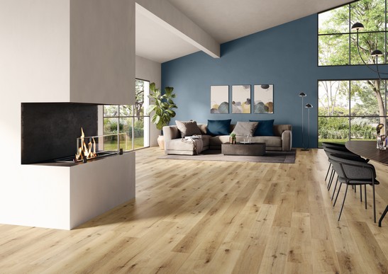 Modern open-plan living room with wood-effect stoneware and white walls and blue