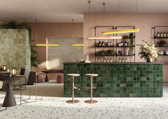 Commercial space: rustic industrial-style bar with colored tiles and terrazzo-effect flooring.