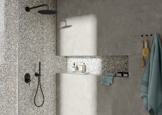 Bathroom with modern shower and mosaic wall tiles in shades of gray