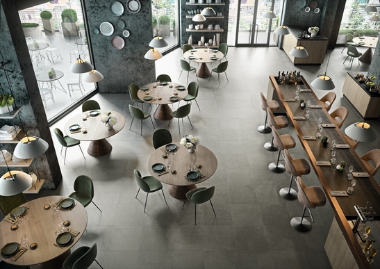 Modern restaurant bar with gray concrete-effect stoneware flooring for an industrial touch
