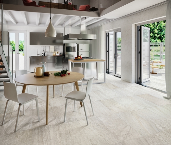 Cuisine moderne avec îlot central dans des tons de blanc avec effet pierre pour une touche de luxe.