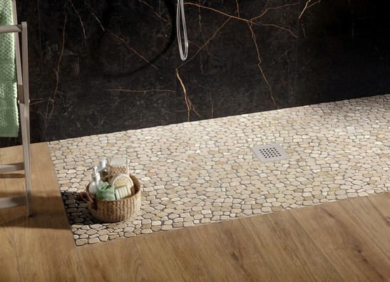 Classic modern bathroom with marble mosaic shower, wood-effect flooring, black marble-effect wall tiles.