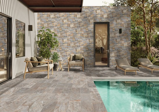 Rustic-modern exterior with pool, stone-effect flooring, and stone wall cladding