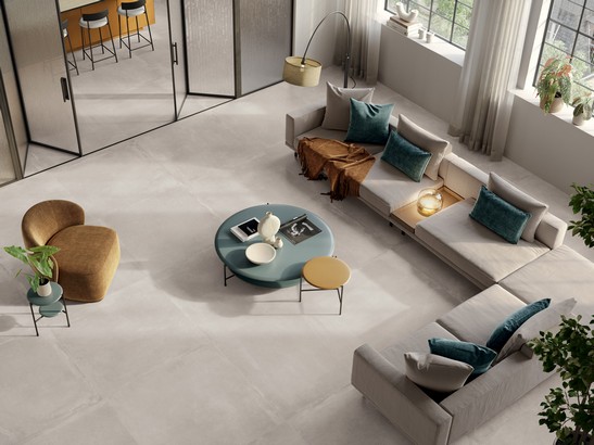 Large modern living room with gray concrete-effect tiles