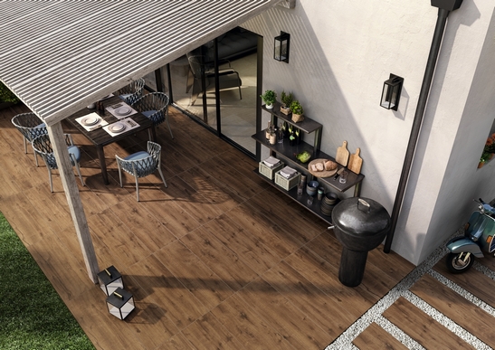 Terrasse couverte moderne avec sol en grès cérame imitation bois foncé pour une touche rustique.